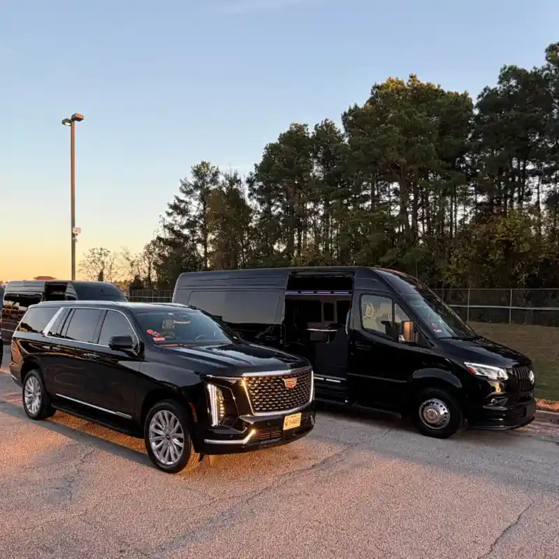 Black luxury SUV and sprinter van parked outdoors Black luxury SUV and sprinter van parked outdoors
