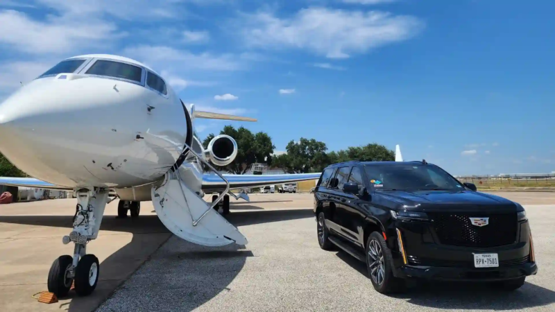 black luxury suv parked beside private jet airplane