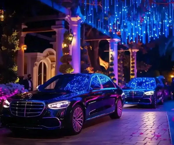 black mercedes luxury sedans at evening wedding venue