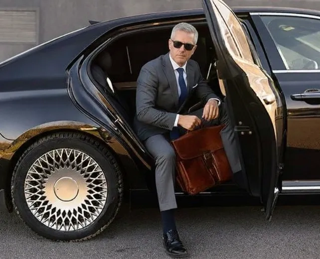 businessman holding briefcase stepping out of luxury car in houston texas