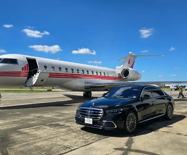 Chauffeured vehicle waiting at a private aviation terminal