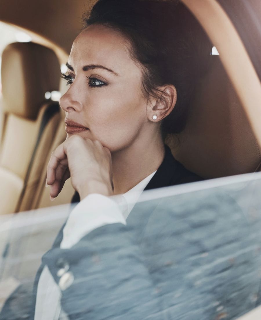 Passenger relaxing in the back seat of a Pro Ride Limo luxury car in Houston